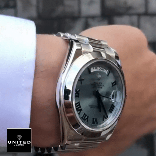 Rolex Day-Date 228206 "Roman Numerals" Handcrafted Clone Quality the man has a Rolex Day-Date II Stainless Steel Ice Blue Roman Dial 218206 Replica