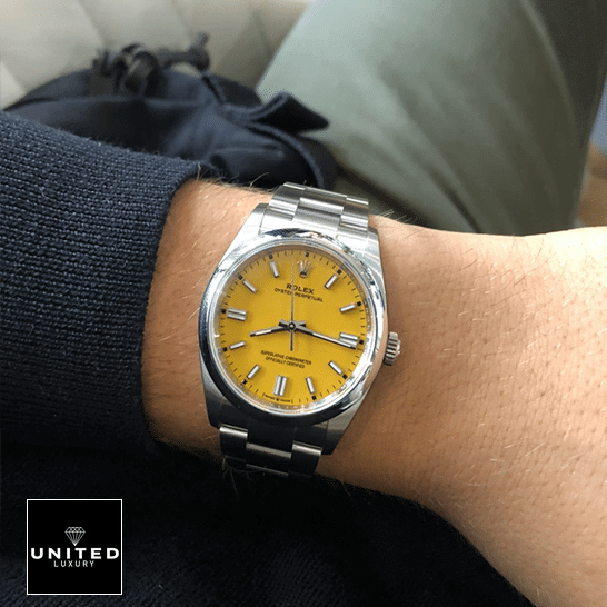 Rolex Oyster Perpetual 124300 "Orange Dial" Deluxe Clone 1:1 rolex oyster perpetual yellow dial 124300 replica man unitedluxurynet 1 Rolex Perpetual 124300 Yellow Dial Stick indices Replica on his arm